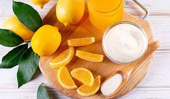 Jelly lemon candies made from gelatin powder, agar-agar, and pectin powder on wooden board