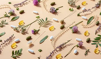 Herbal supplements and vitamins with plants and flowers