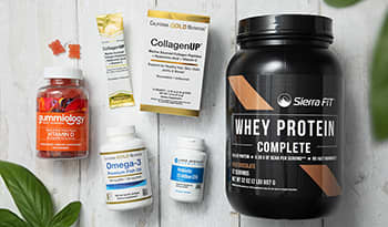 Supplements laid out on white table: vitamin D, collagen, fish oil, probiotics, whey protein