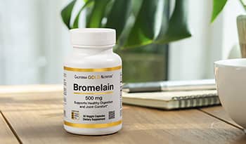 Bromelain supplement on desk table with plant in background