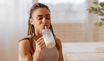 Healthy woman drinking protein shake 