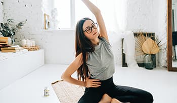 Woman stretching and doing yoga at home