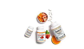 Bottles of vitamin c, vitamin d, and vitamin b on white background with fruit