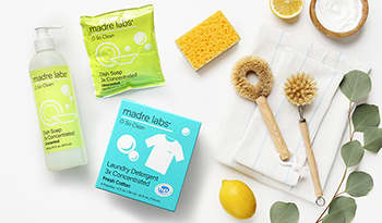 Eco-friendly cleaning and household item flat lay of laundry detergent, soap, sponges