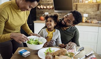 Young family eating healthy holiday meal