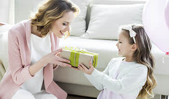 Daughter giving gift to mother on Mother's Day