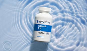 Hyaluronic acid supplement bottle on water background