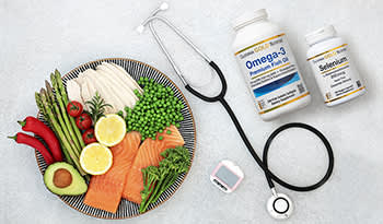Plate of healthy foods, supplements, glucose monitor, and stethoscope