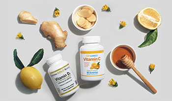 Lemon, ginger, honey, vitamin C, Vitamin D flat lay on white background with flowers