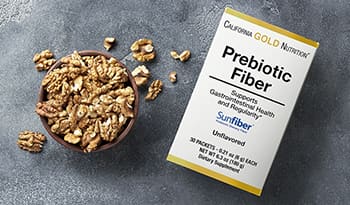 Cup of walnuts next to prebiotic fiber supplements