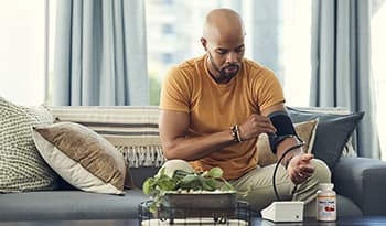 Male checking blood pressure at home