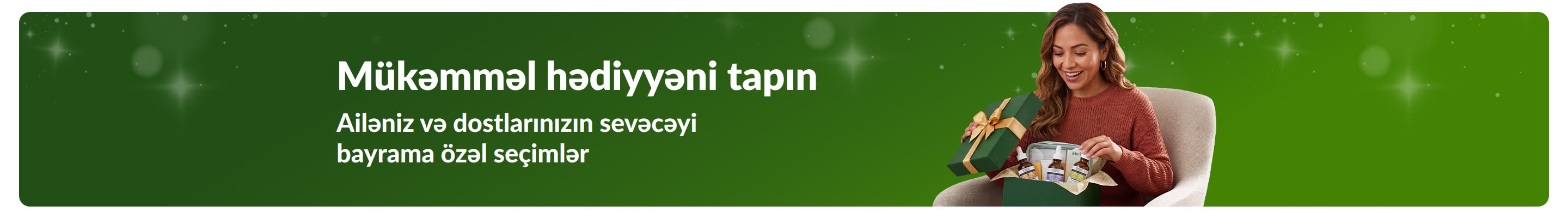 Mükəmməl hədiyyəni tapın. Ailəniz və dostlarınızın sevəcəyi bayrama özəl seçimlər. Gülümsəyən bir qadın hədiyyə qutusu açır.