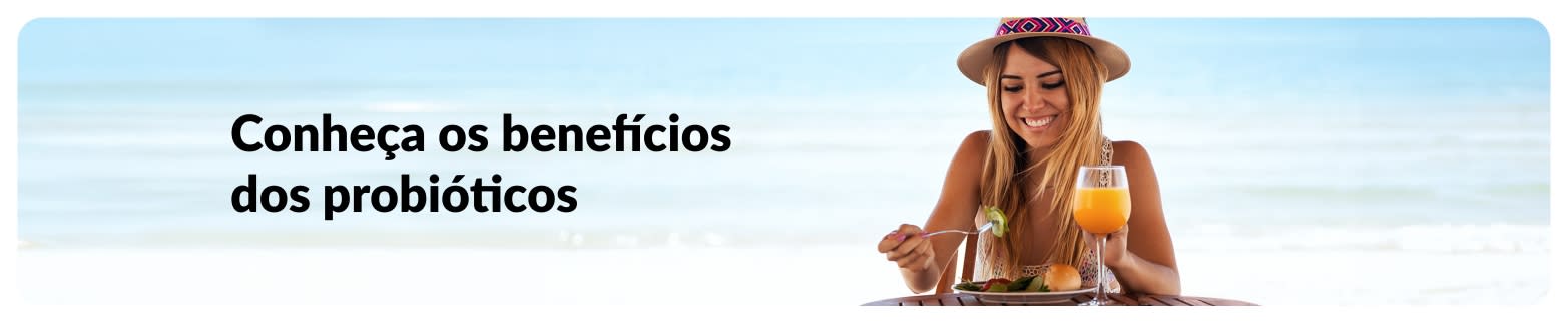 Banner de artigo sobre probióticos com uma mulher comendo à beira-mar, destacando os benefícios dos probióticos.