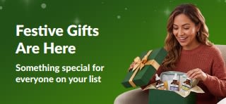 Festive Gifts banner featuring a smiling woman opening a green gift box filled with skincare serums, with text reading 'Festive Gifts - Something special for everyone on your list.'
