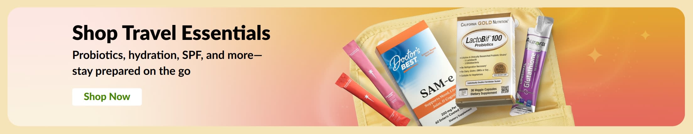 Banner featuring travel essentials arranged in a travel bag with a “Shop Now” button.